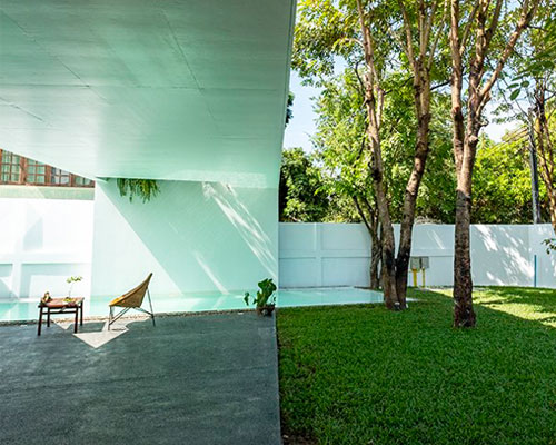the white house by saola architects fuses indoors with garden space in laos