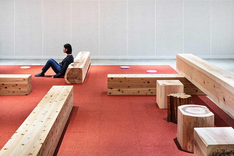 torafu architects renovates museum gallery with cedar logs as benches and tables in japan