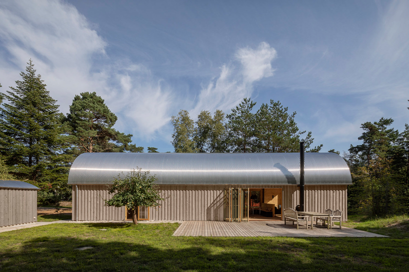 valbæk brørup architects tops wooden house in denmark with vaulted steel roof