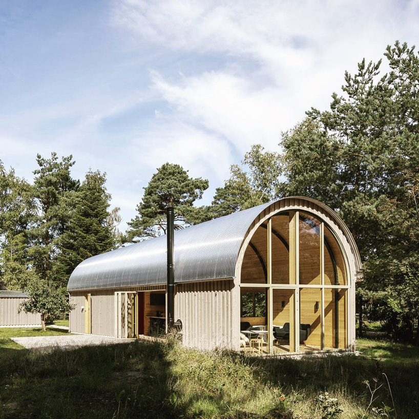 valbæk brørup architects tops wooden house in denmark with vaulted steel roof - 1
