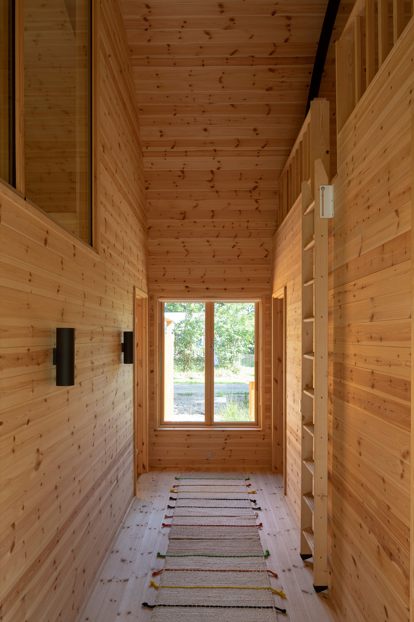 valbæk brørup architects tops wooden house in denmark with vaulted steel roof - 5