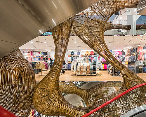 VTN architects' bamboo 'bird nest' fluidly grows through vietnam's flagship UNIQLO