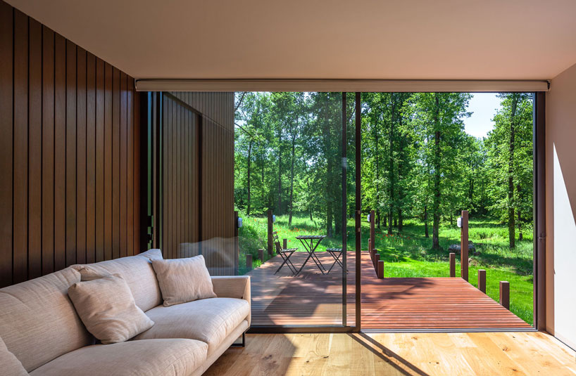 arnau estudi d'arquitectura embeds the 'forest stone' house into a sloped site in spain designboom