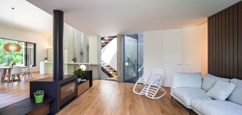 arnau estudi d'arquitectura embeds the 'forest stone' house into a sloped site in spain designboom