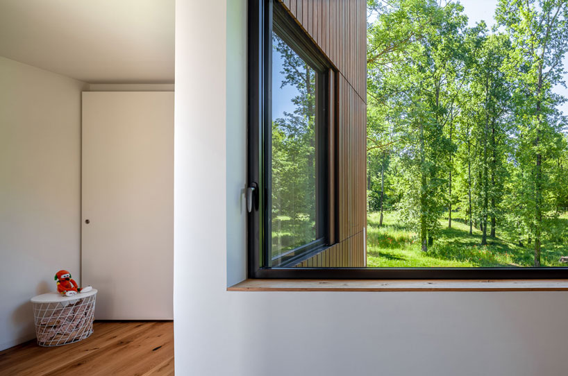 arnau estudi d'arquitectura embeds the 'forest stone' house into a sloped site in spain designboom