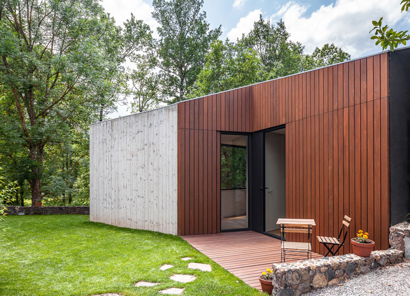 arnau estudi d'arquitectura embeds the 'forest stone' house into a sloped site in spain designboom