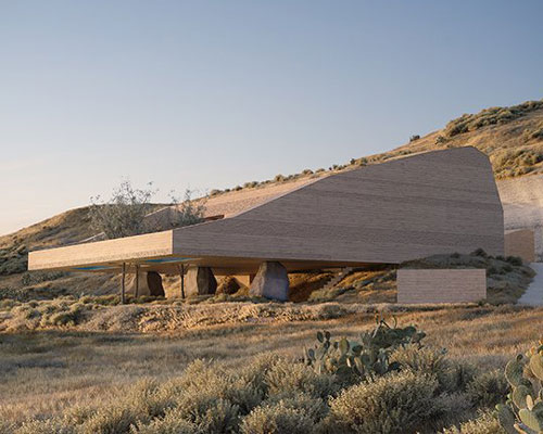 kapsimalis architects envisions two houses carved from rock in santorini