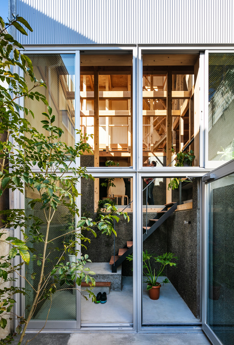 kiyoaki takeda's timber house with five retaining walls in tokyo merges nature with artefact