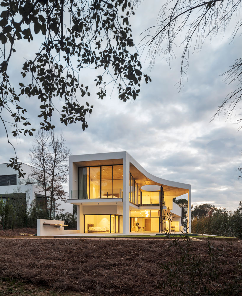 the wedged volume of lagula's 'gruyere house' optimizes both privacy and views in girona designboom