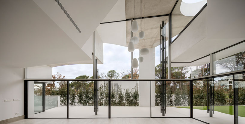 the wedged volume of lagula's 'gruyere house' optimizes both privacy and views in girona designboom