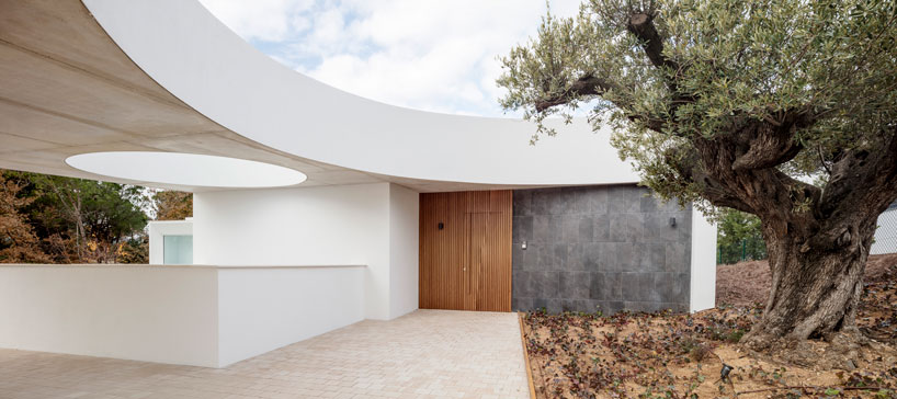 the wedged volume of lagula's 'gruyere house' optimizes both privacy and views in girona designboom