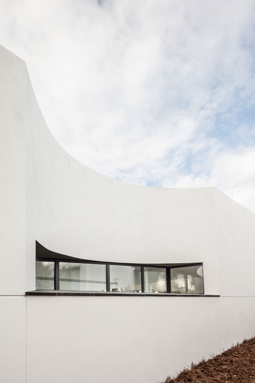 the wedged volume of lagula's 'gruyere house' optimizes both privacy and views in girona designboom