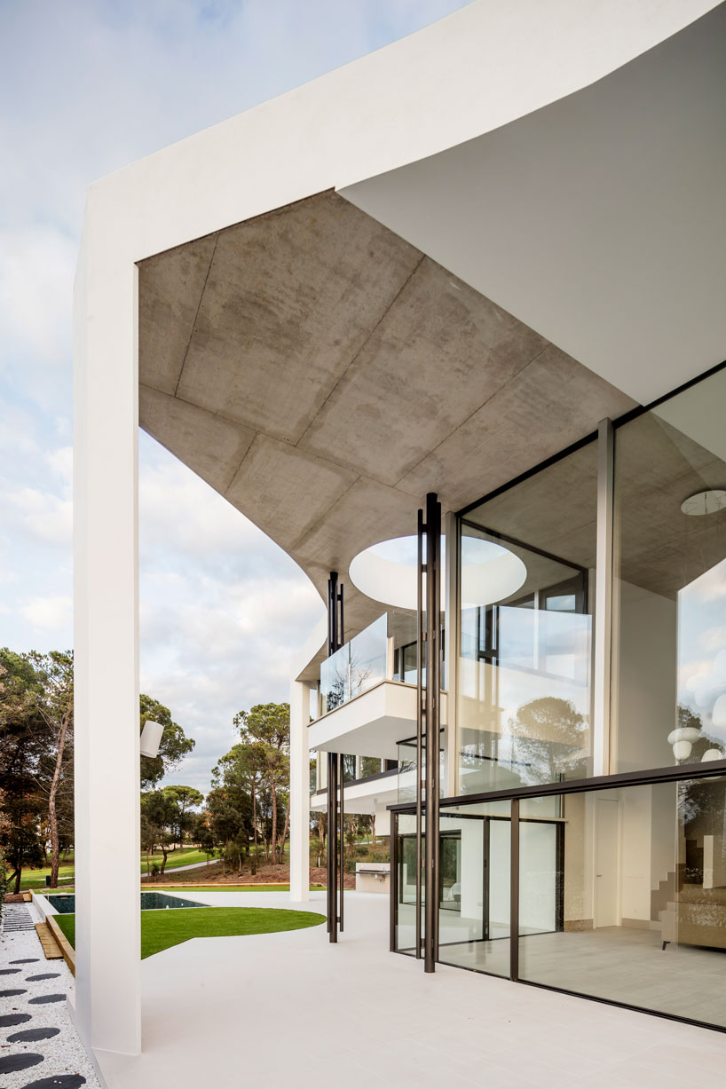 the wedged volume of lagula's 'gruyere house' optimizes both privacy and views in girona designboom