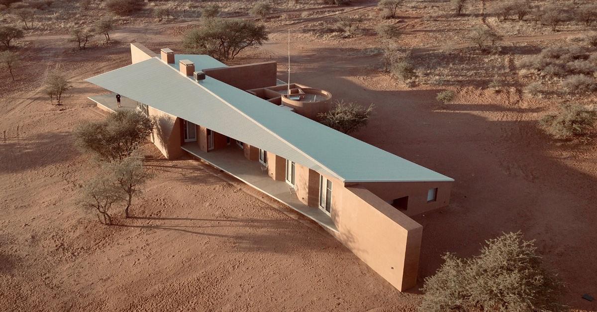 slee & co. architects' red earth game lodge emerges from the namibian
