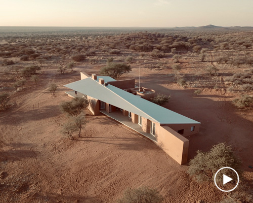 slee & co. architects' red earth game lodge emerges from the namibian landscape