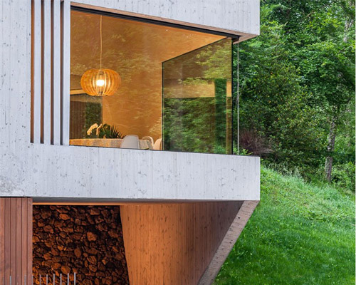arnau estudi d'arquitectura embeds the 'forest stone' house into a sloped site in spain