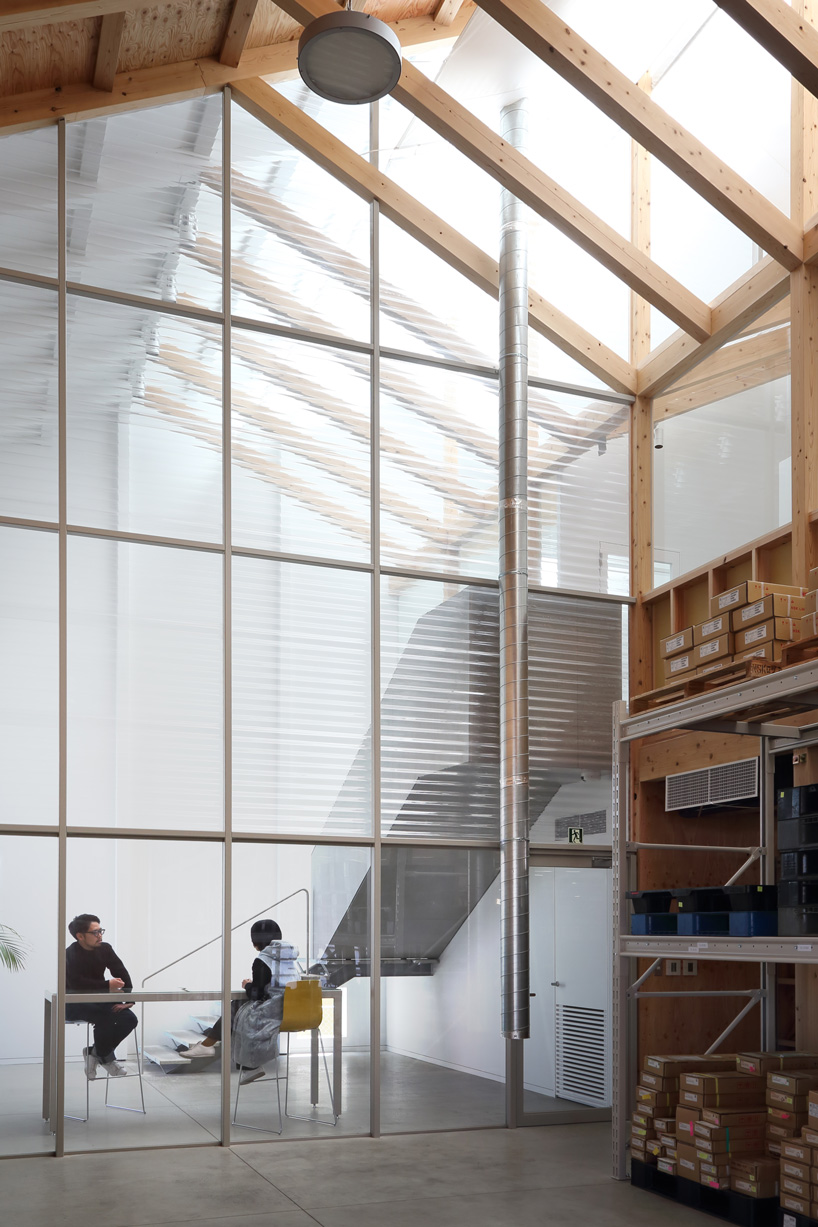 arii irie architects tops light-filled warehouse in ageo, japan, with exposed timber roof truss