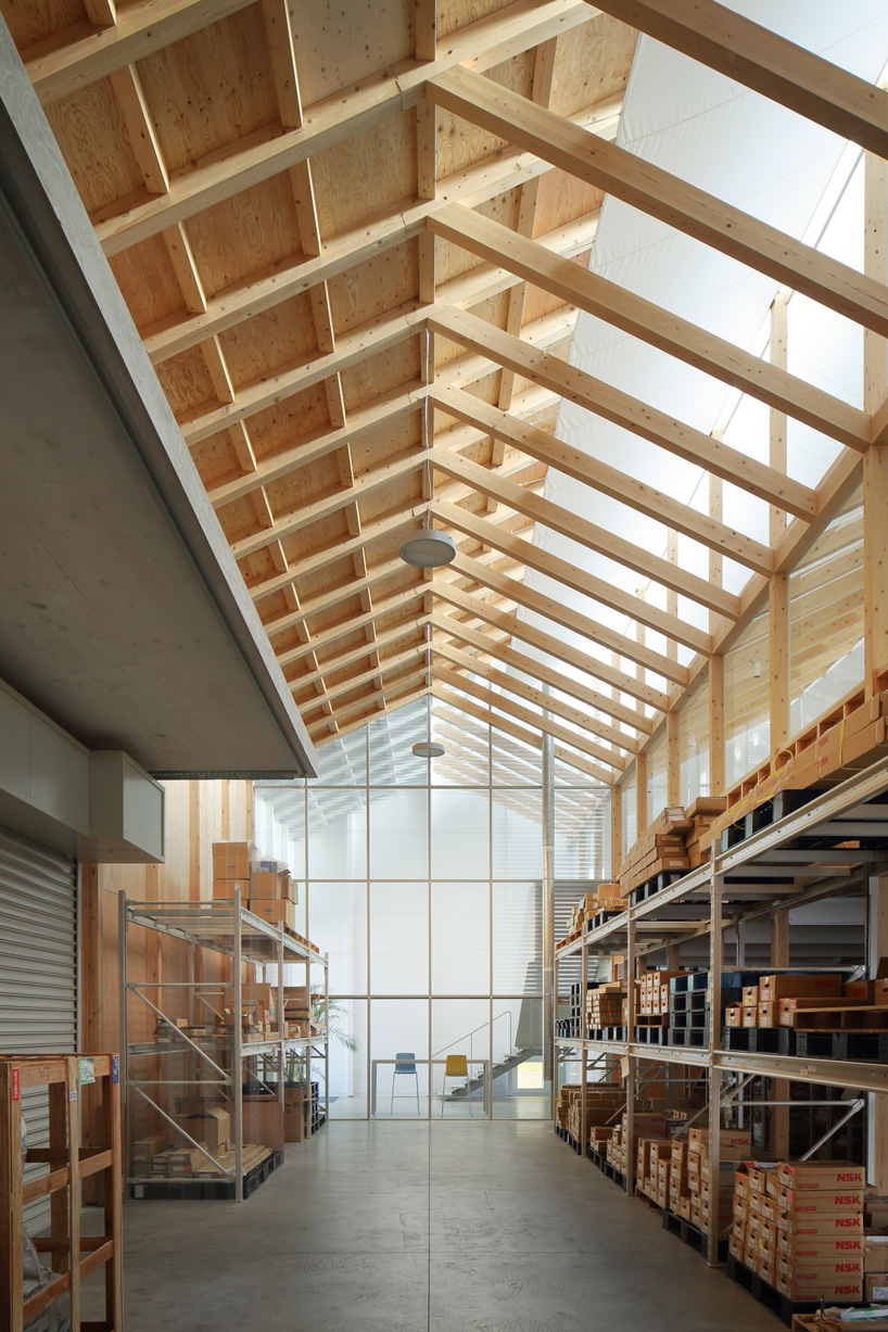 arii irie architects tops light-filled warehouse in ageo, japan, with exposed timber roof truss