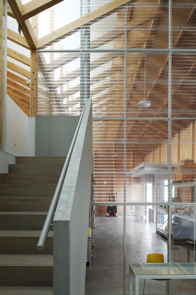 arii irie architects tops light-filled warehouse in ageo, japan, with exposed timber roof truss