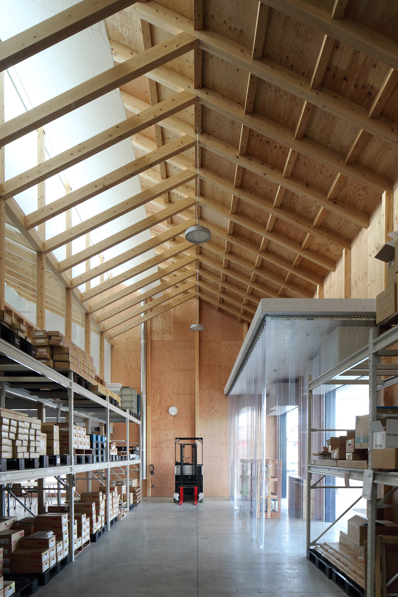 arii irie architects tops light-filled warehouse in ageo, japan, with exposed timber roof truss