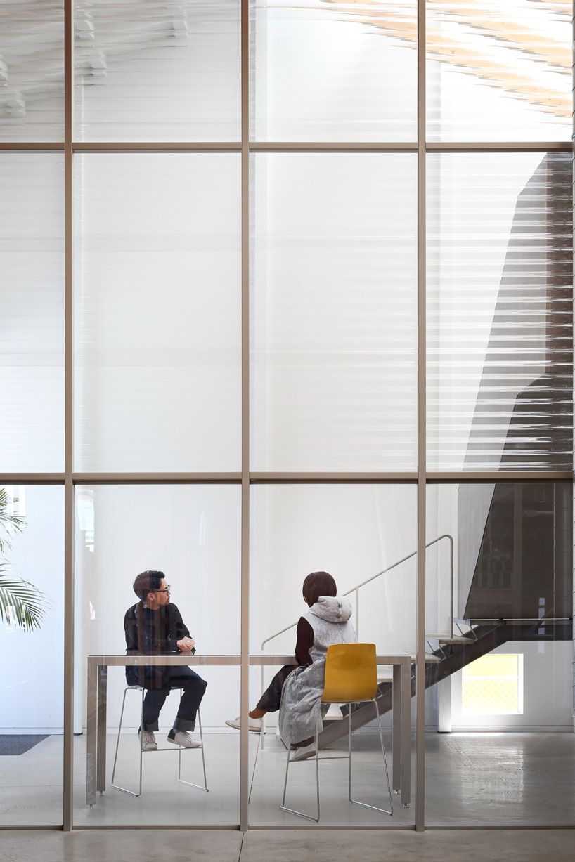 arii irie architects tops light-filled warehouse in ageo, japan, with exposed timber roof truss
