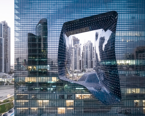 zaha hadid's 'opus' building in dubai photographed by laurian ghinitoiu