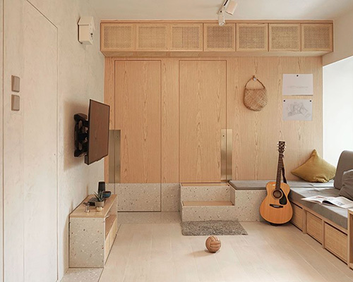 absence from island completes apartment interior in hong kong with rattan, wood + terrazzo