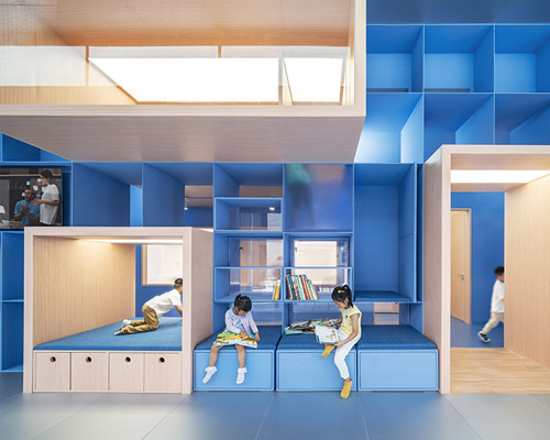 crossboundaries organizes Qkids education space in china around a 'blue spine'