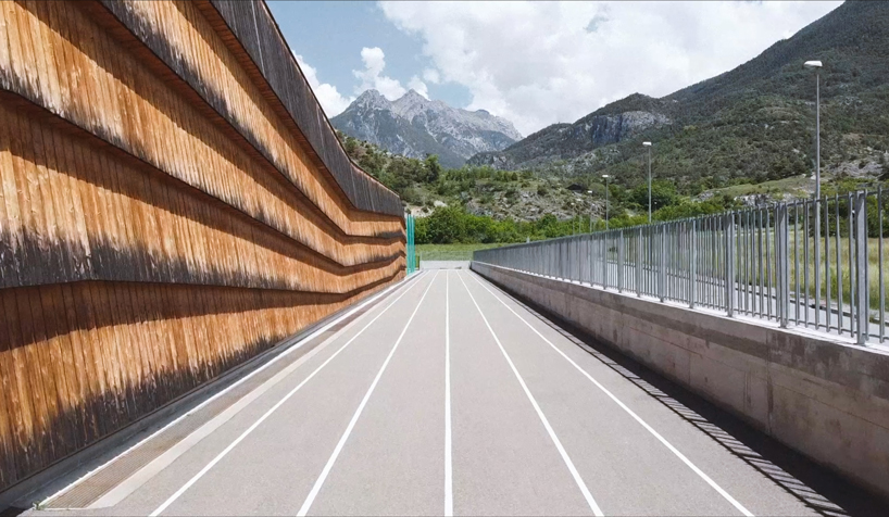 larch cladding folds over gymnasium guillestre to echo the landscape designboom
