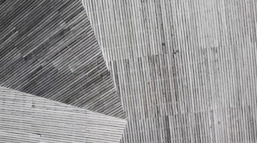 larch cladding folds over gymnasium guillestre to echo the landscape designboom