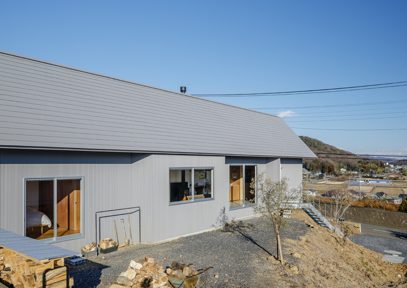SNARK + OUVI top wooden house in saishikada, japan, with pitched roof