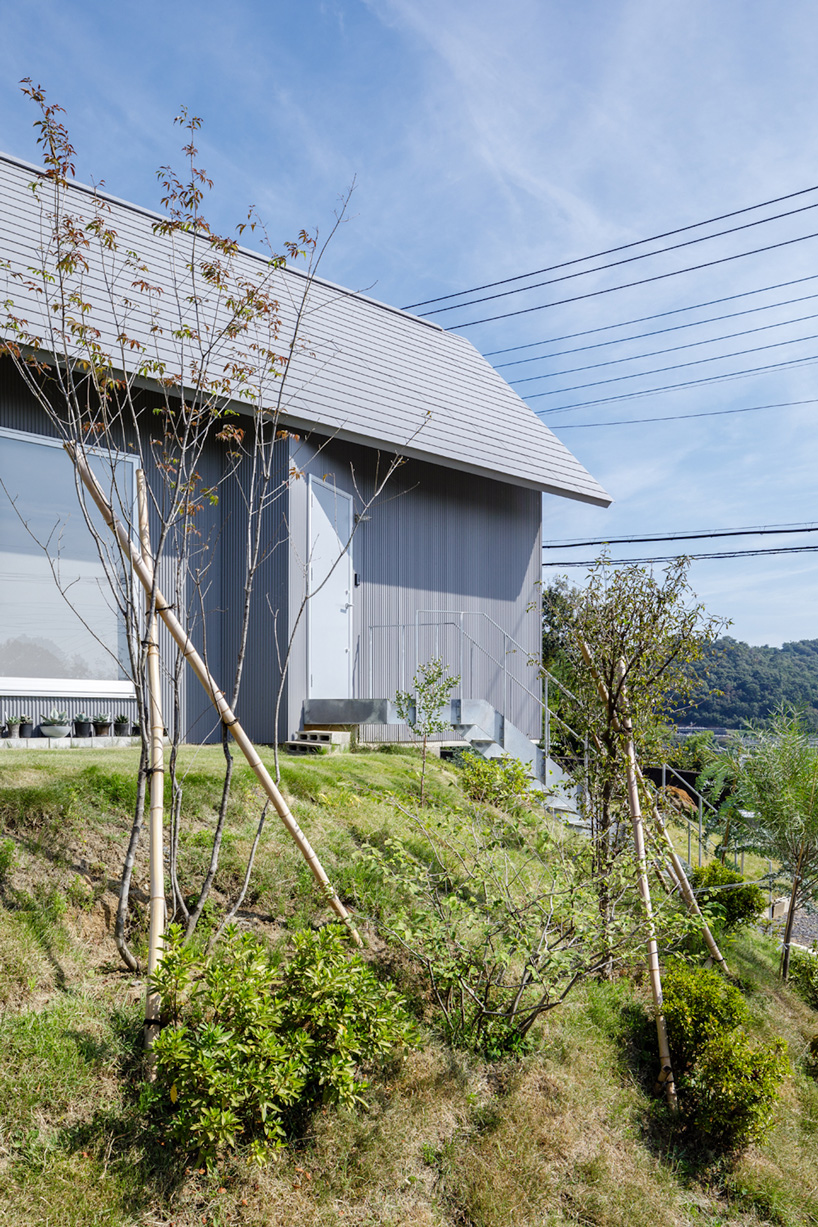 SNARK + OUVI top wooden house in saishikada, japan, with pitched roof