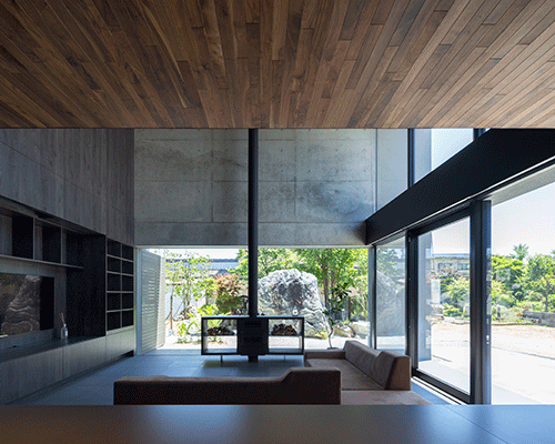apollo architects builds concrete dwelling with rock garden in japan