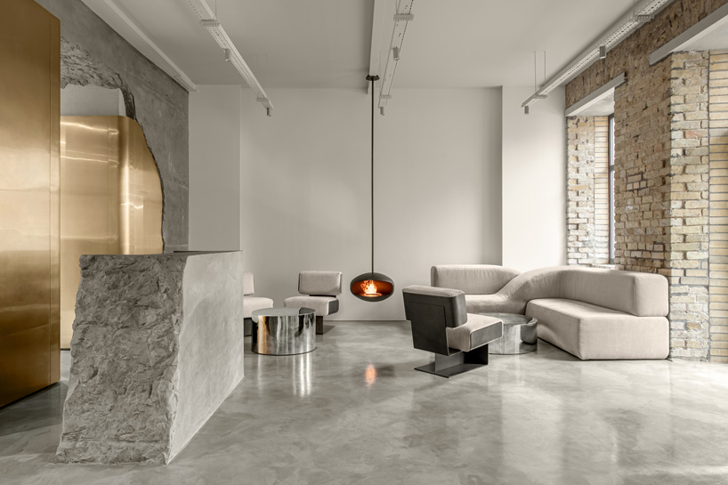 balbek bureau finishes gender-neutral beauty salon in kyiv with concrete arch + gold details