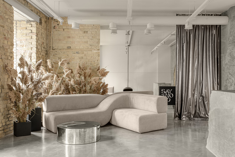 balbek bureau finishes gender-neutral beauty salon in kyiv with concrete arch + gold details