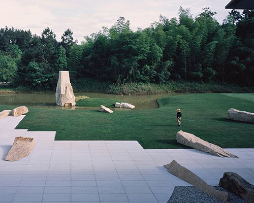 the passage of time garden in china balances natural forms with man-made elements