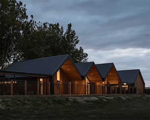 a series of barn-like forms completes childcare centre by smith architects in new zealand