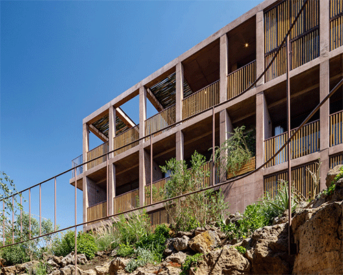 terracotta-colored concrete volumes + wooden lattice frames complete hotel in mexico