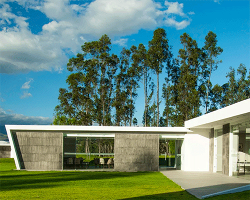 white interconnected volumes with slanted walls compose weekend house in ecuador