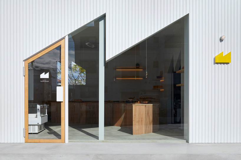 airhouse completes 'bakery tsukiakari' in japan with half-moon wooden counter 
