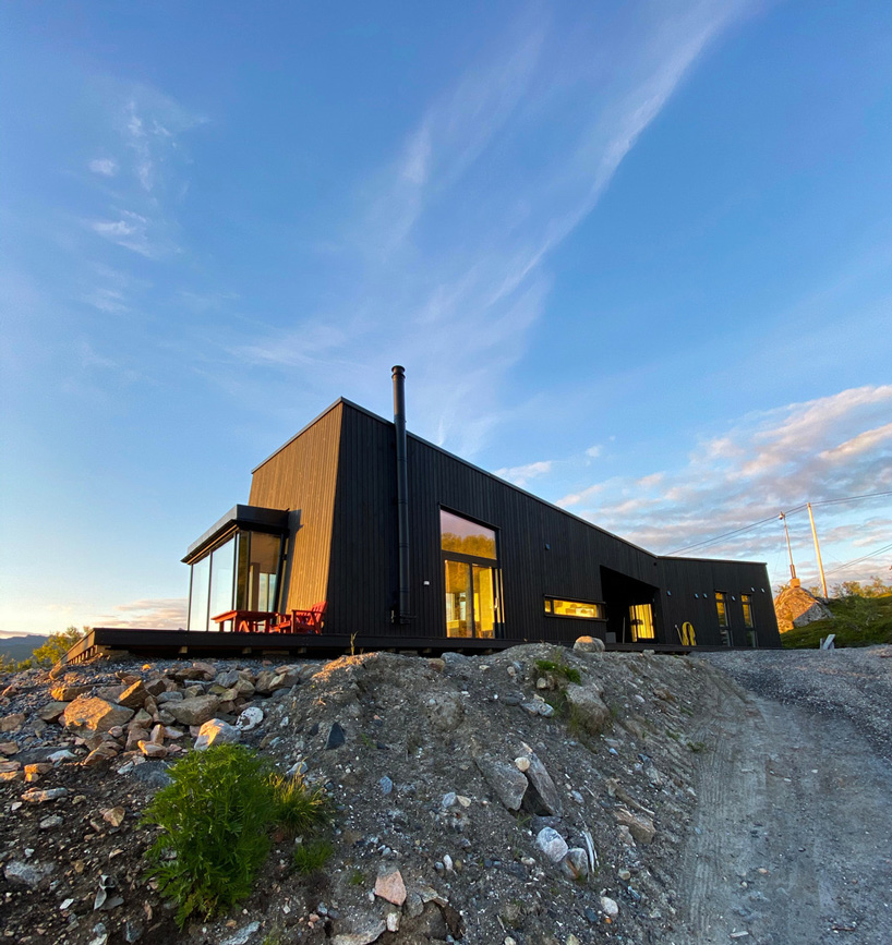 the cabin sits on a rock with views of the surrounding mountains