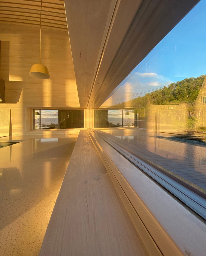 the interior offers a warm, cozy atmosphere built in wood