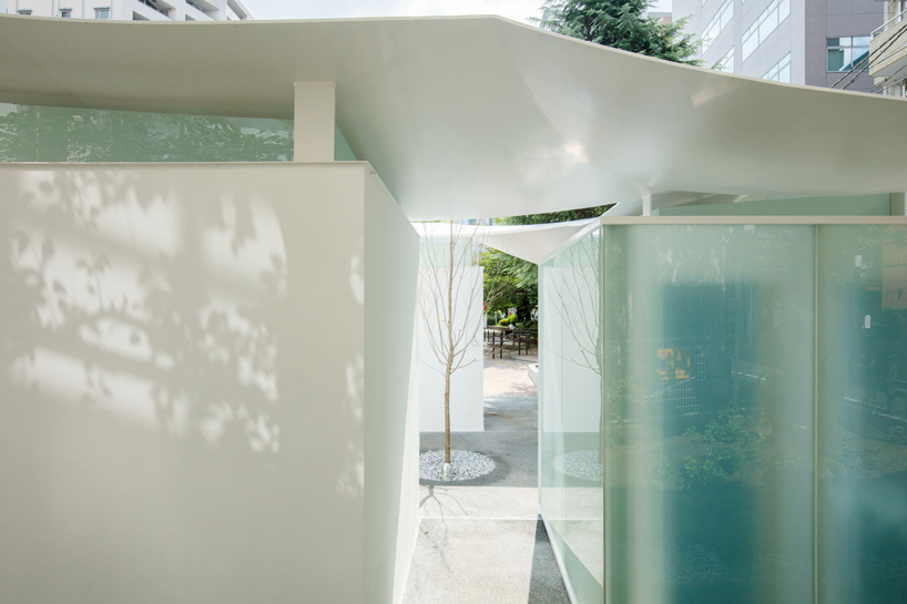 fumihiko maki's tokyo toilet is designed with a courtyard and curved roof designboom