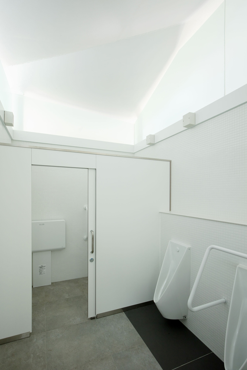 fumihiko maki's tokyo toilet is designed with a courtyard and curved roof designboom