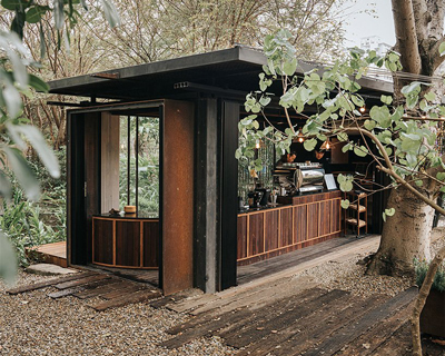 infeel architects turns an old shipping container into a rustic coffee shop in taiwan