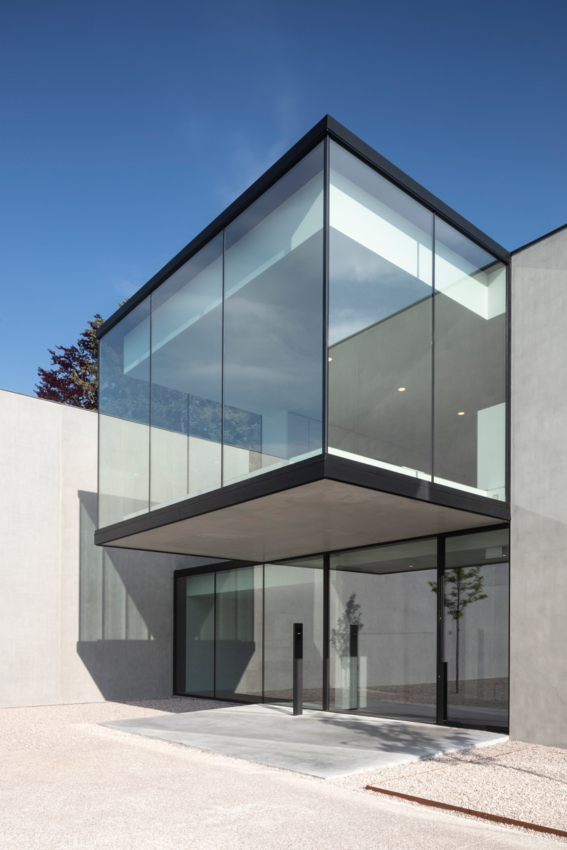 an overhanging glass cube above the entrance provides shelter