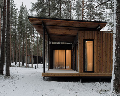 prefab cabin hotel by rhizome settles isolated within karelian landscape, in russia