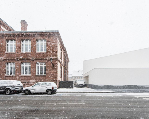 rhb architects designs a gymnasium in france to align with neighboring buildings