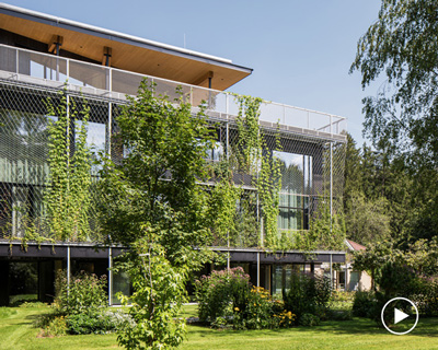 snøhetta wraps ASI reisen's timber office building in austria with a 'green curtain'