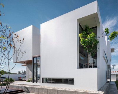 TOUCH architect inserts glass voids for growing trees in the 'stack-cube' house in thailand